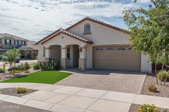 mediterranean / spanish-style house with a garage