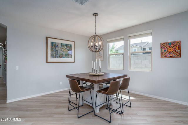 dining area featuring a notable chandelier and light hardwood / wood-style floors