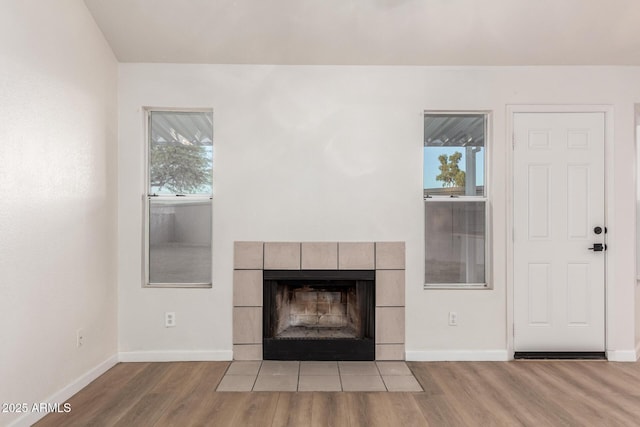 1405 N Jamaica Way, Gilbert, AZ 85234 - unfurnished living room featuring wood finished floors and a fireplace