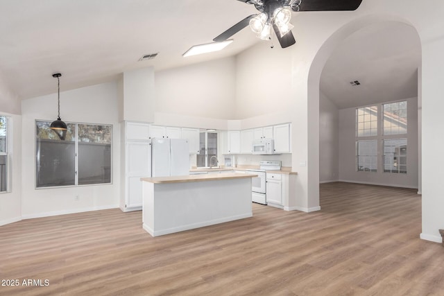 1405 N Jamaica Way, Gilbert, AZ 85234 - kitchen with white appliances, white cabinetry, ceiling fan, light countertops, and arched walkways