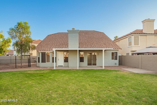 1405 N Jamaica Way, Gilbert, AZ 85234 - back of house featuring a patio, a fenced backyard, a chimney, and stucco siding