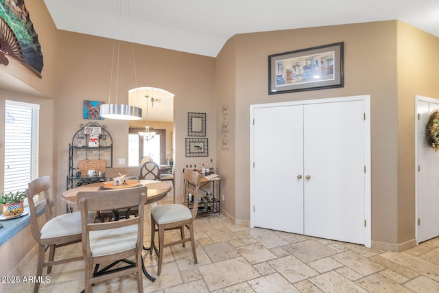 15740 N 91st Dr, Peoria, AZ 85382 - dining room with high vaulted ceiling, a chandelier, stone tile flooring, and baseboards