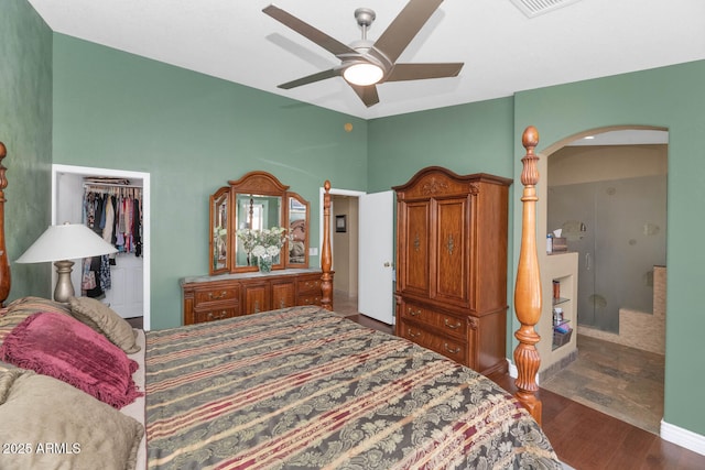 15740 N 91st Dr, Peoria, AZ 85382 - bedroom featuring arched walkways, wood finished floors, a closet, a walk in closet, and ceiling fan