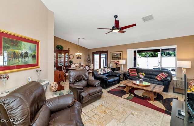15740 N 91st Dr, Peoria, AZ 85382 - living room with lofted ceiling, ceiling fan, stone tile floors, and a chandelier