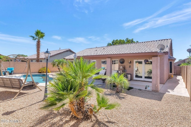 15740 N 91st Dr, Peoria, AZ 85382 - rear view of property with a tiled roof, a fenced backyard, stucco siding, and a patio area