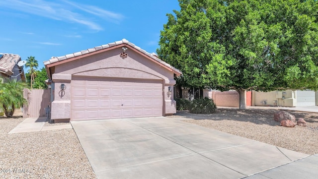 15740 N 91st Dr, Peoria, AZ 85382 - view of front facade featuring driveway, a garage, stucco siding, and a tiled roof