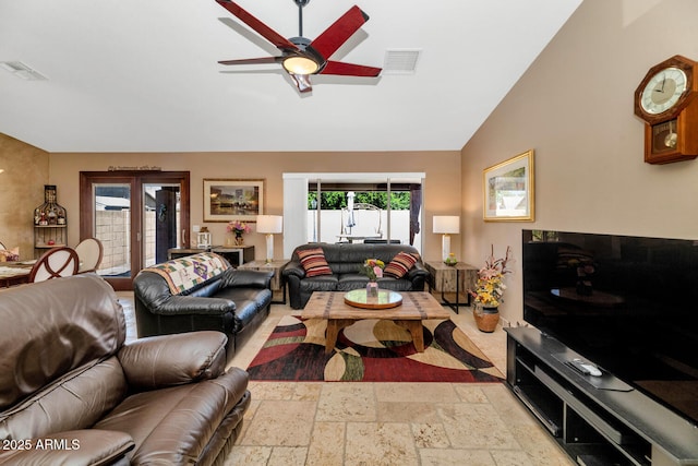 15740 N 91st Dr, Peoria, AZ 85382 - living room featuring a ceiling fan, stone tile floors, and lofted ceiling