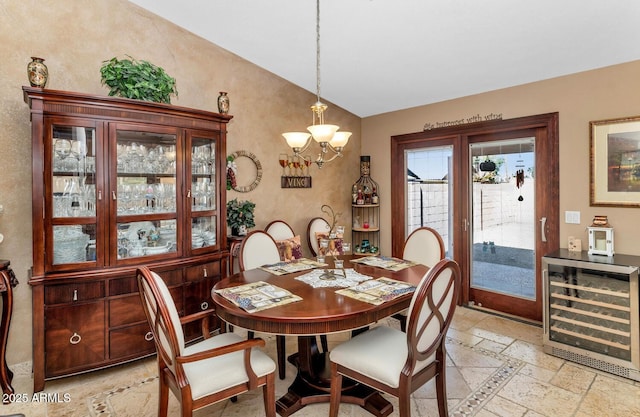 15740 N 91st Dr, Peoria, AZ 85382 - dining room with lofted ceiling, wine cooler, stone tile floors, and a chandelier