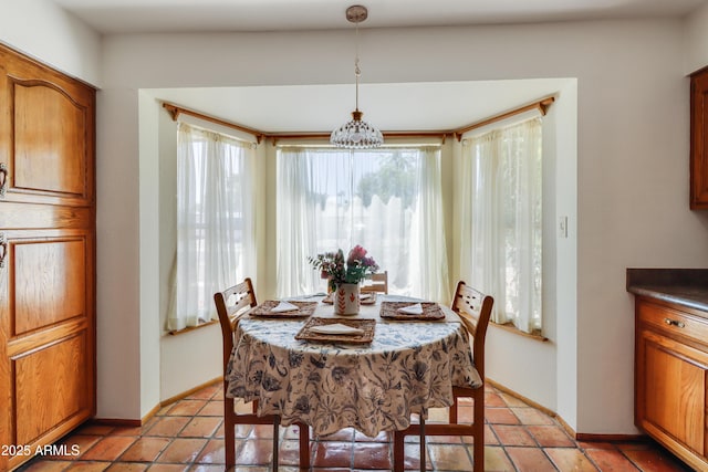 7526 E Edgemont Ave, Scottsdale, AZ 85251 - dining room featuring a chandelier and baseboards