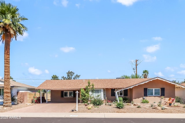 7526 E Edgemont Ave, Scottsdale, AZ 85251 - ranch-style home with stucco siding, concrete driveway, roof with shingles, and an attached carport
