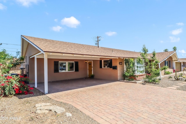 7526 E Edgemont Ave, Scottsdale, AZ 85251 - single story home featuring stucco siding, roof with shingles, decorative driveway, and a carport
