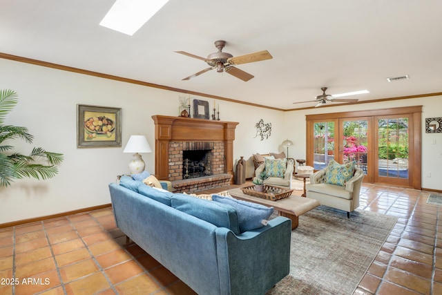 7526 E Edgemont Ave, Scottsdale, AZ 85251 - living room featuring baseboards, a ceiling fan, a fireplace, a skylight, and ornamental molding