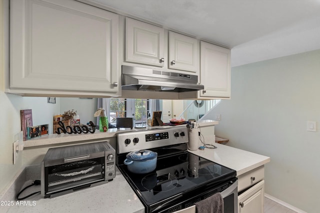 kitchen featuring white cabinets and stainless steel electric range