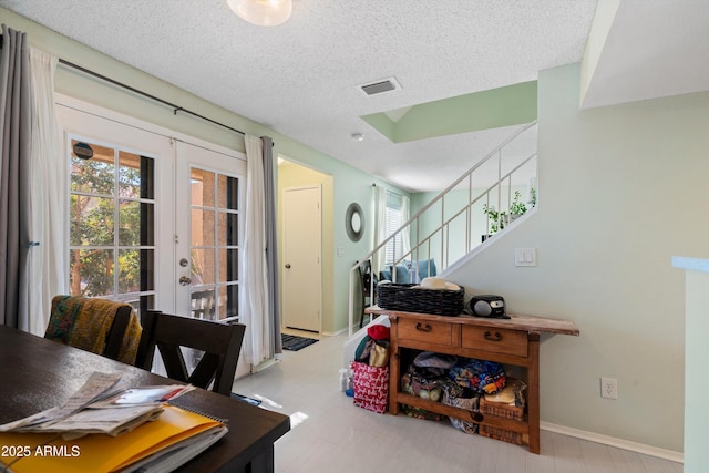 dining space featuring a textured ceiling