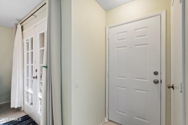 doorway with a textured ceiling