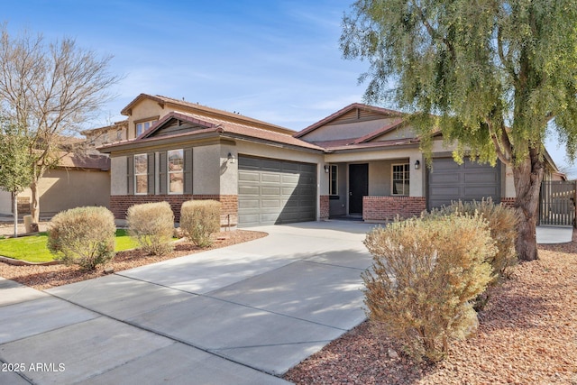 single story home with brick siding, stucco siding, concrete driveway, and a garage