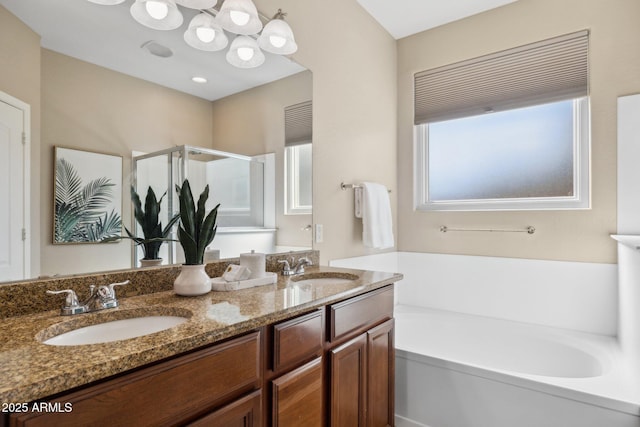 full bathroom featuring a sink, a garden tub, a stall shower, and double vanity