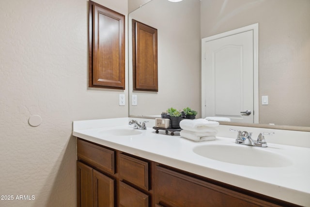 bathroom featuring a sink and double vanity