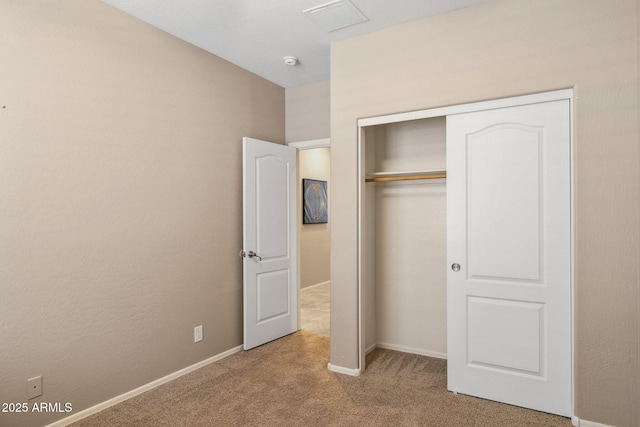 unfurnished bedroom with a closet, baseboards, and carpet floors