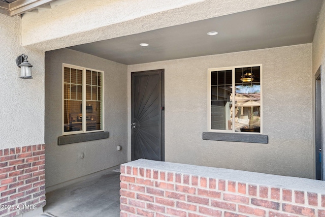 property entrance with stucco siding