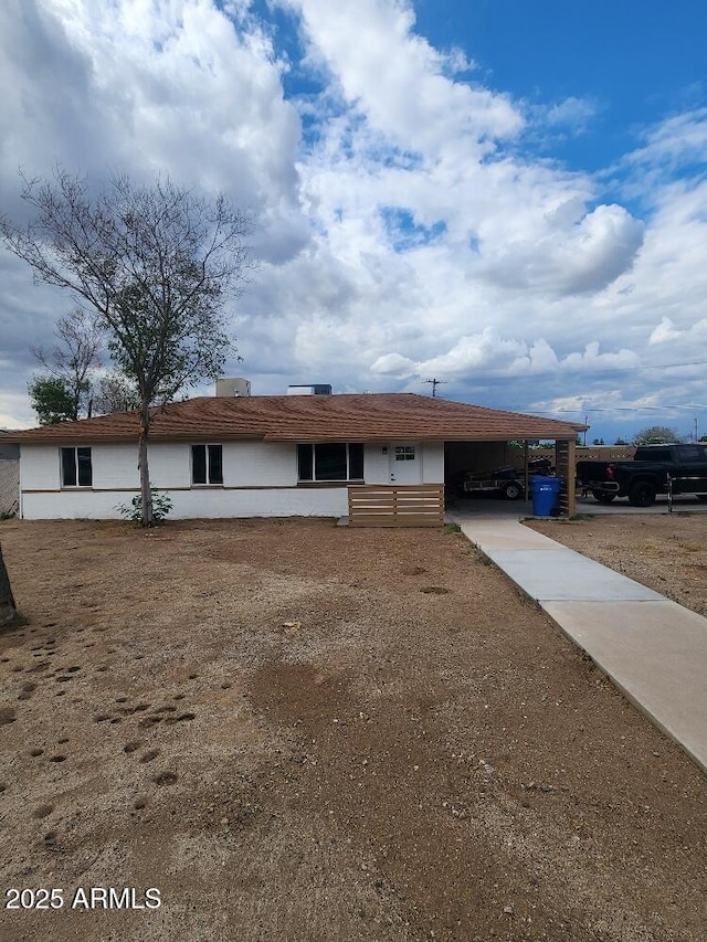 view of front of home featuring an attached carport and driveway