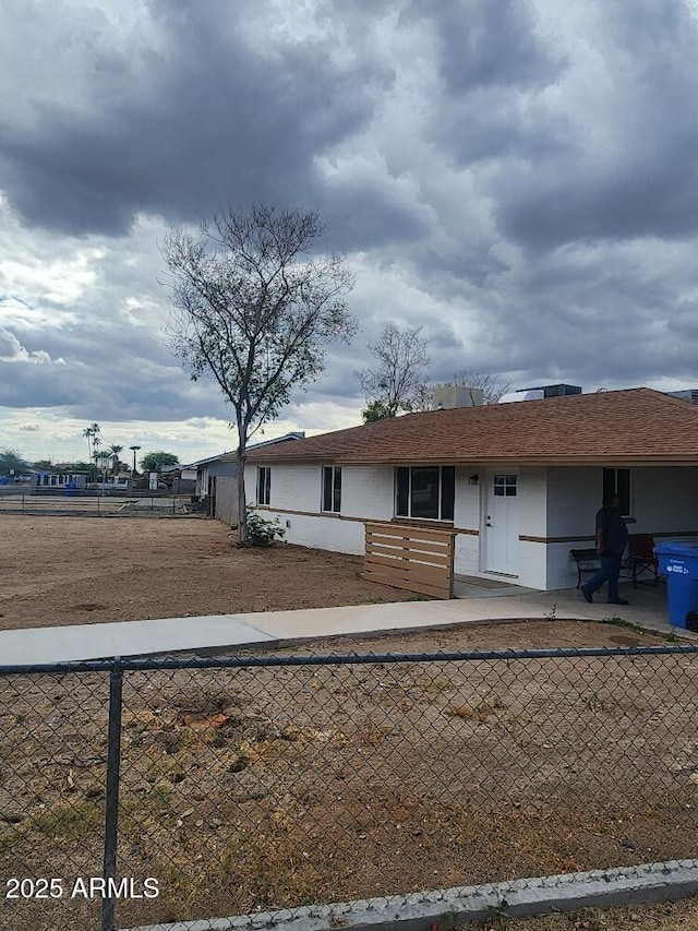 ranch-style home with fence and stucco siding
