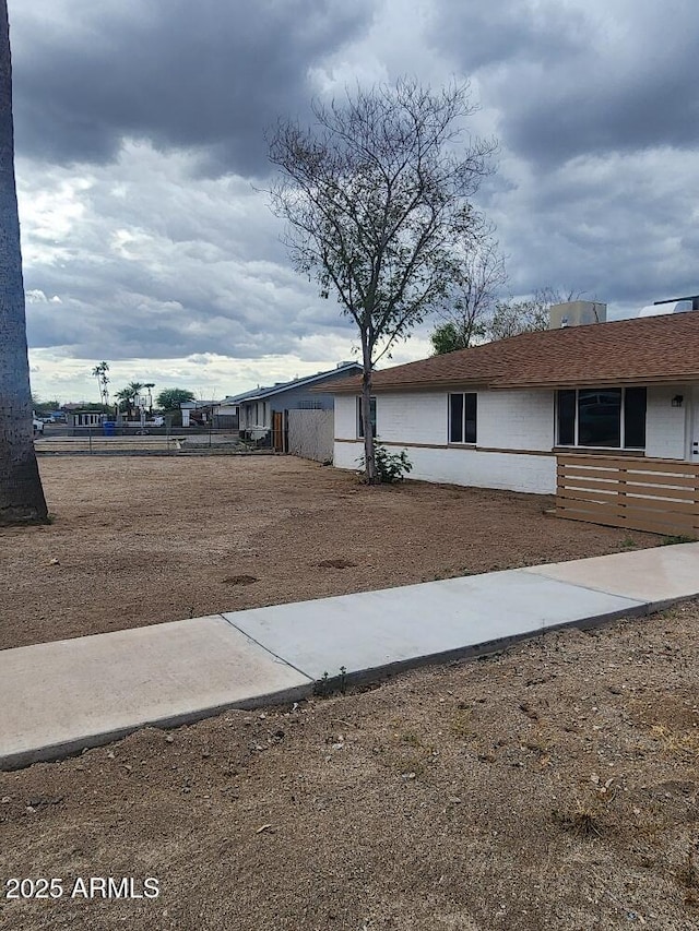 view of side of home with fence