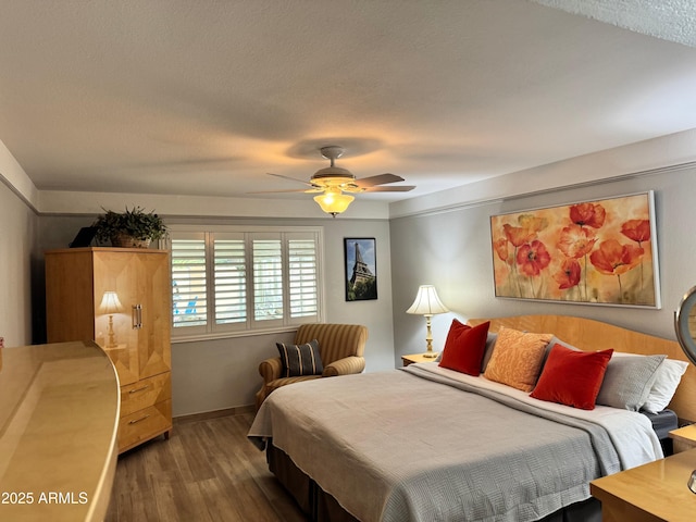 bedroom featuring dark wood-type flooring and ceiling fan