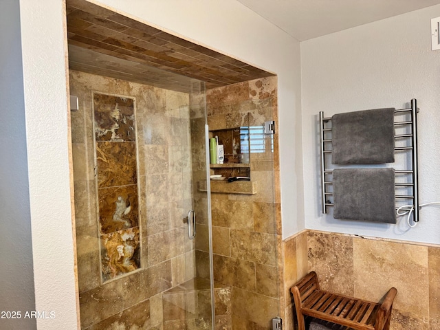 bathroom with radiator heating unit and a tile shower