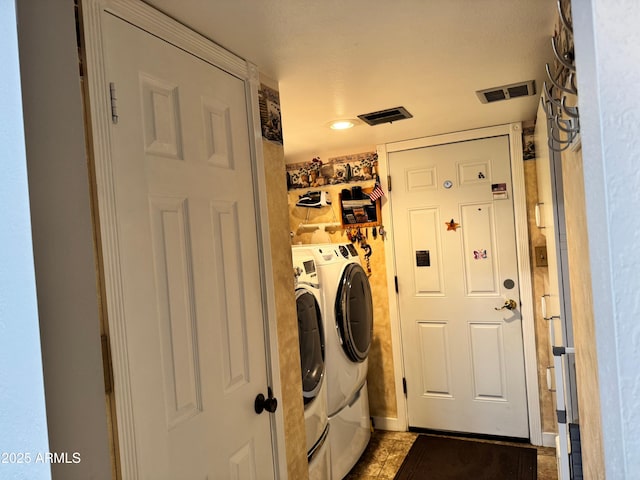 clothes washing area with washer and clothes dryer