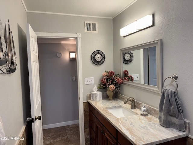 bathroom with ornamental molding and vanity