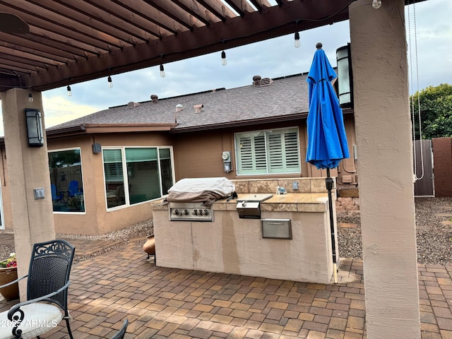 view of patio / terrace featuring area for grilling, a grill, and a pergola