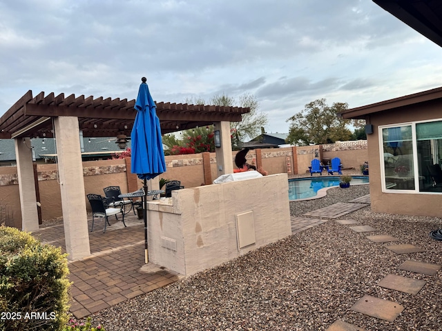 view of patio featuring a fenced in pool, a pergola, and exterior bar