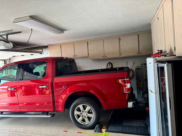 garage with white refrigerator, a garage door opener, and water heater