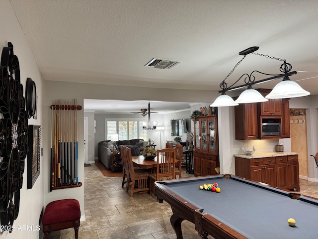 game room featuring ceiling fan, pool table, and a textured ceiling