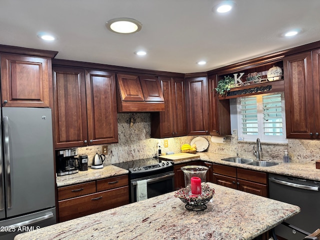 kitchen featuring sink, backsplash, stainless steel appliances, light stone countertops, and custom range hood