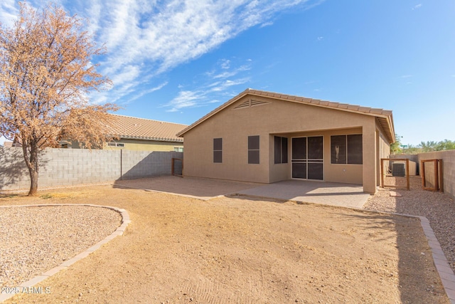 back of house featuring stucco siding, a fenced backyard, and a patio