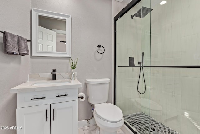 bathroom featuring vanity, toilet, and a shower with shower door