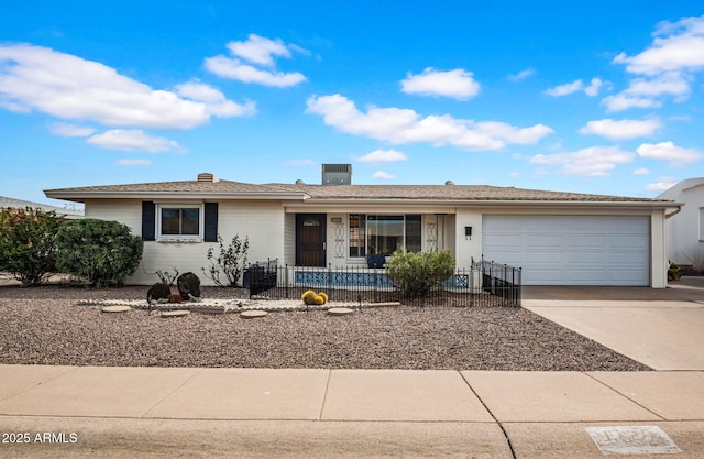 single story home with driveway and an attached garage