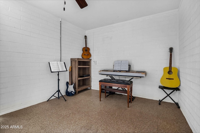 misc room with brick wall, a ceiling fan, and tile patterned floors