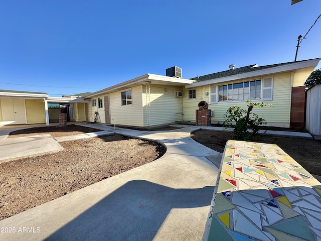 ranch-style home with central air condition unit