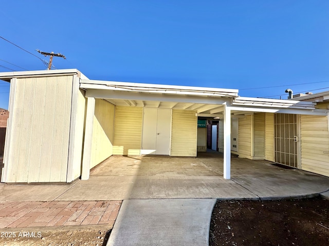 doorway to property featuring a carport