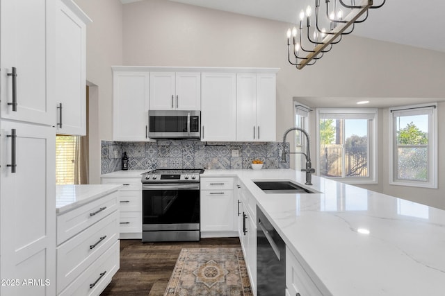 kitchen with decorative light fixtures, sink, an inviting chandelier, white cabinetry, and stainless steel appliances