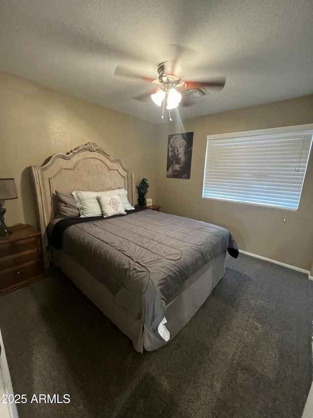 bedroom with carpet flooring, a ceiling fan, visible vents, and a textured ceiling