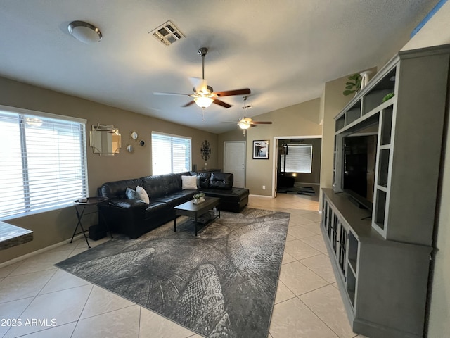 living area featuring visible vents, baseboards, ceiling fan, vaulted ceiling, and light tile patterned floors