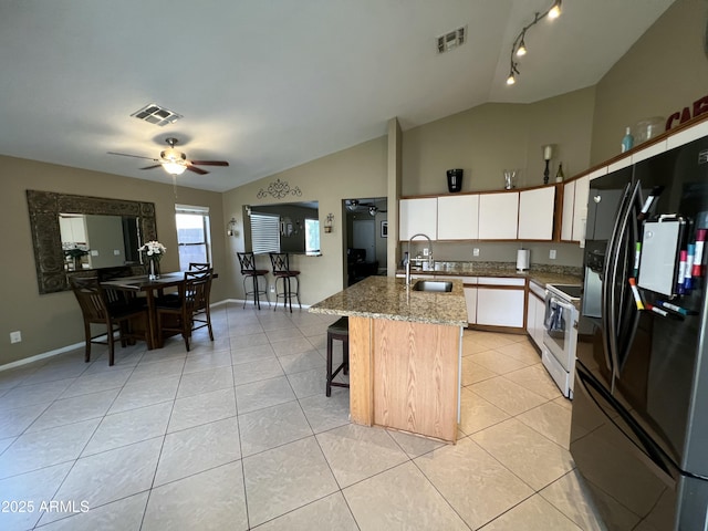 kitchen with a sink, white electric range, visible vents, and black refrigerator with ice dispenser