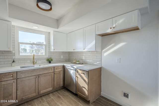 kitchen featuring white cabinets, dishwasher, and sink