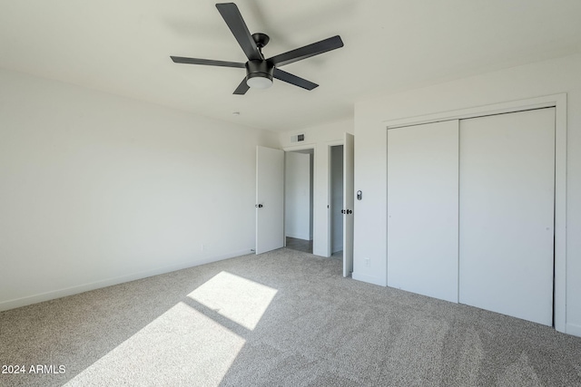 unfurnished bedroom with carpet flooring, a closet, and ceiling fan