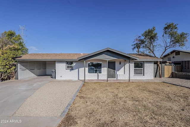 1436 E Downing St, Mesa, AZ 85203 - single story home with a carport, brick siding, driveway, and roof with shingles