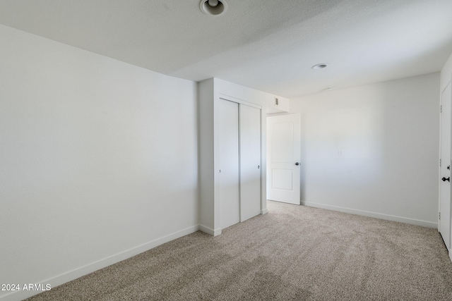 unfurnished bedroom featuring a closet and carpet